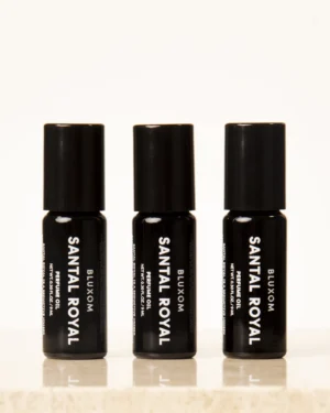 bluxom santal royal roll-on perfume oil in a sleek black bottle with sandalwood, cardamom, amber, and musk notes.