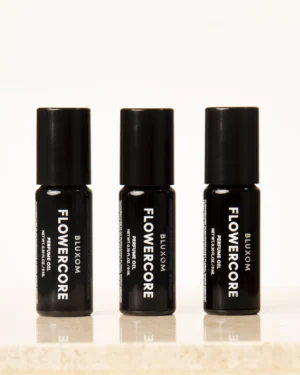 bluxom flowercore roll-on perfume oil in a black glass bottle with tuberose, jasmine, coconut flower, and musk notes.